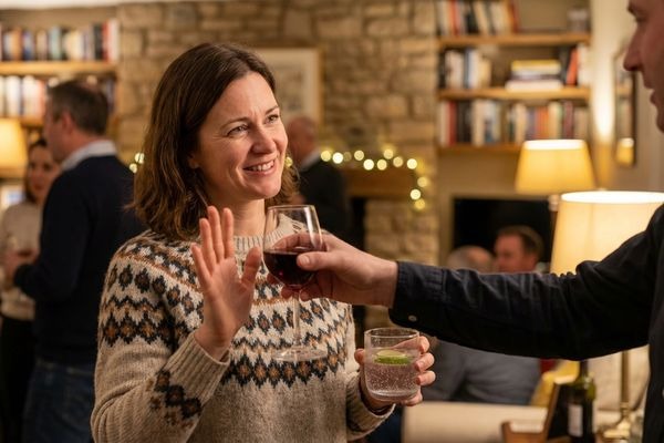 Woman confidently declining alcohol at social gathering