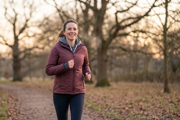 Woman exercising outdoors in winter with determination